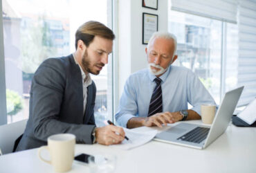Young businessman cooperating with experienced colleague